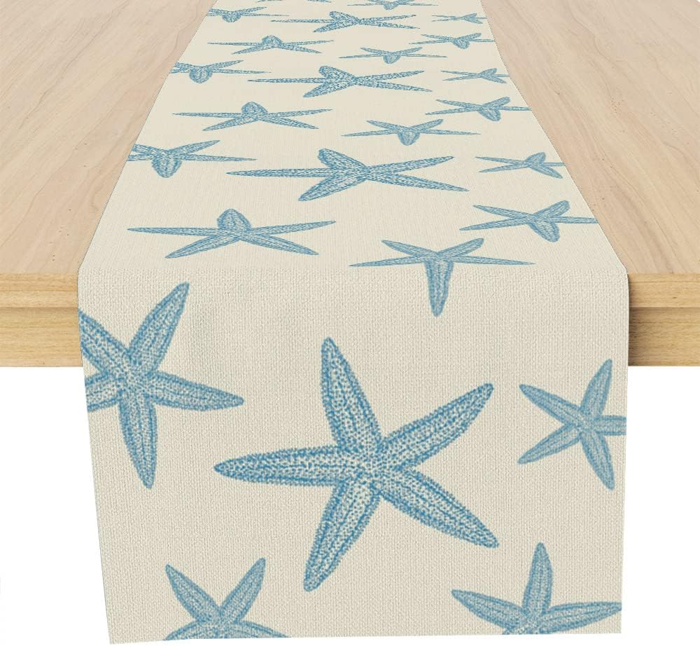 muktoujaumai-blue-starfish-burlap-table-runner-13x72-inches-01 A Muktoujaumai blue starfish burlap table runner, 13x72 inches, laid flat on a dining table, showcasing its star pattern.
